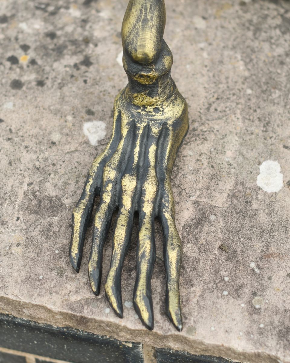 Close up of intricate foot detail on skeleton garden sculpture