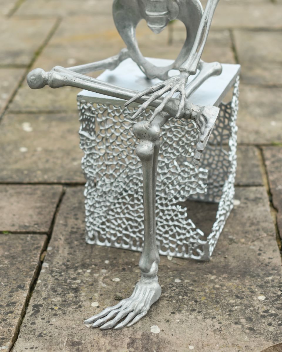 Close up of legs and base detail on silver skeleton garden ornament