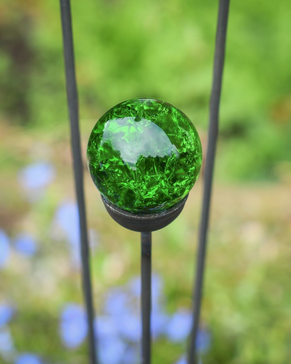 Close up of intricate detail on green marble suncatcher garden stake