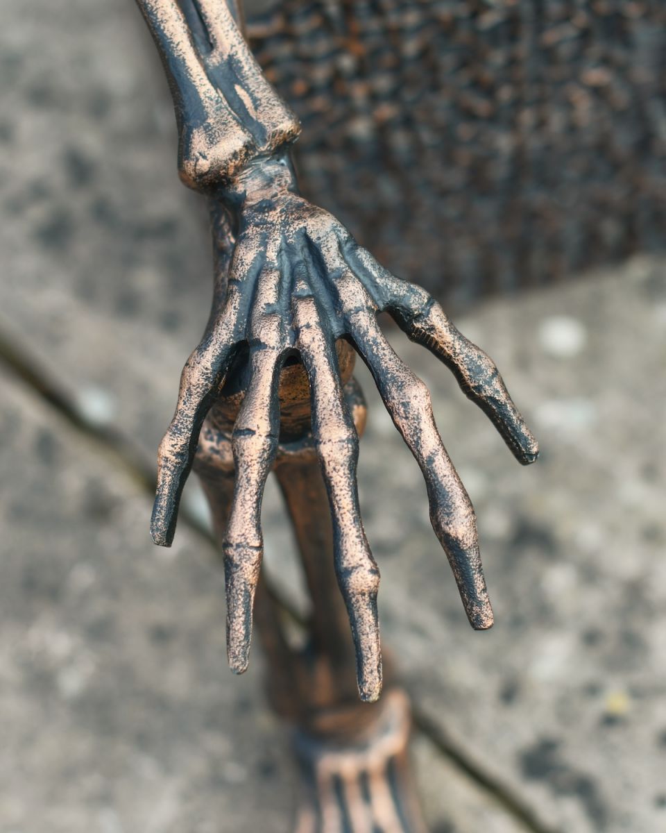 Close up of intricate hand detail on outdoor skeleton statue