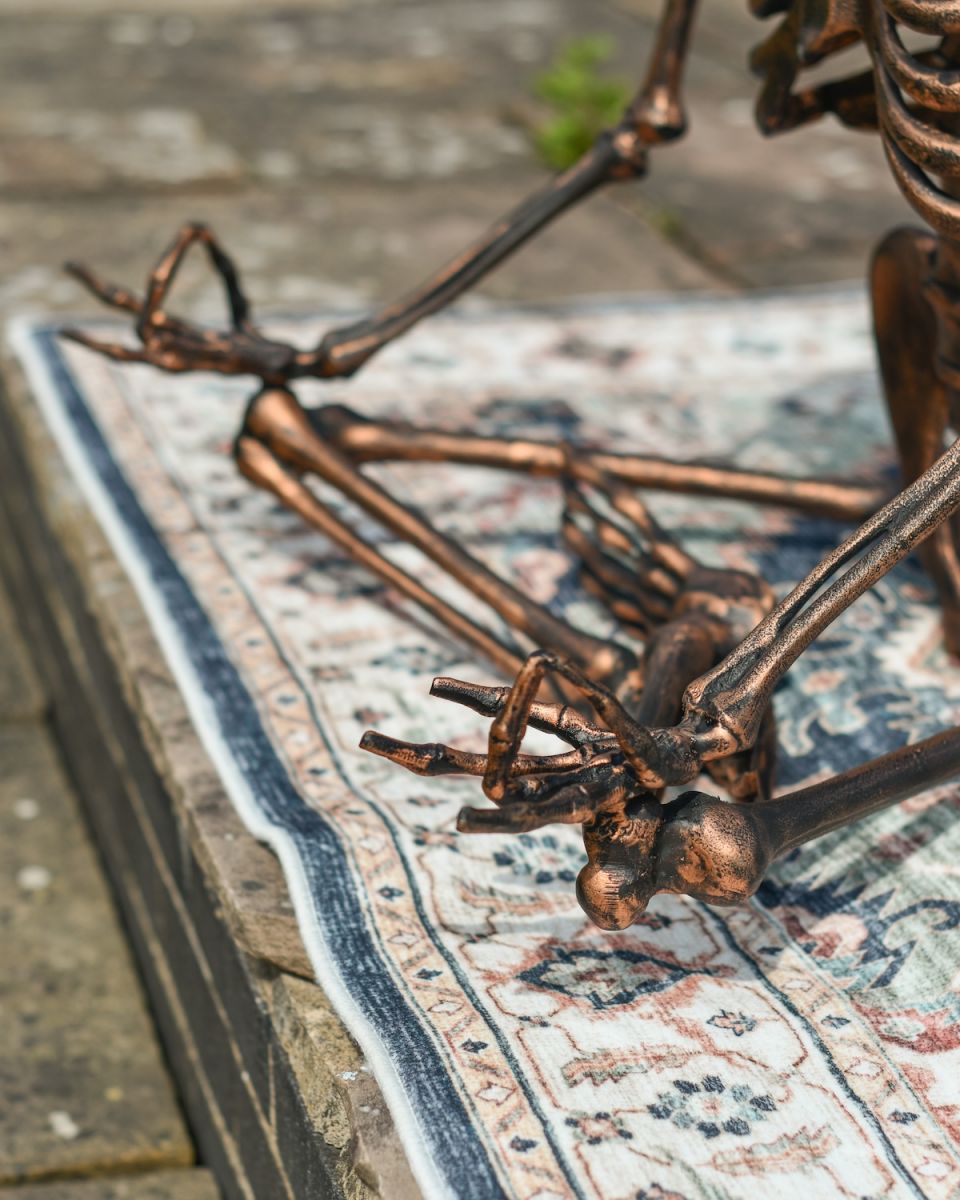 Close up of intricate hand detail on meditating hand detail on skeleton outdoor sculpture