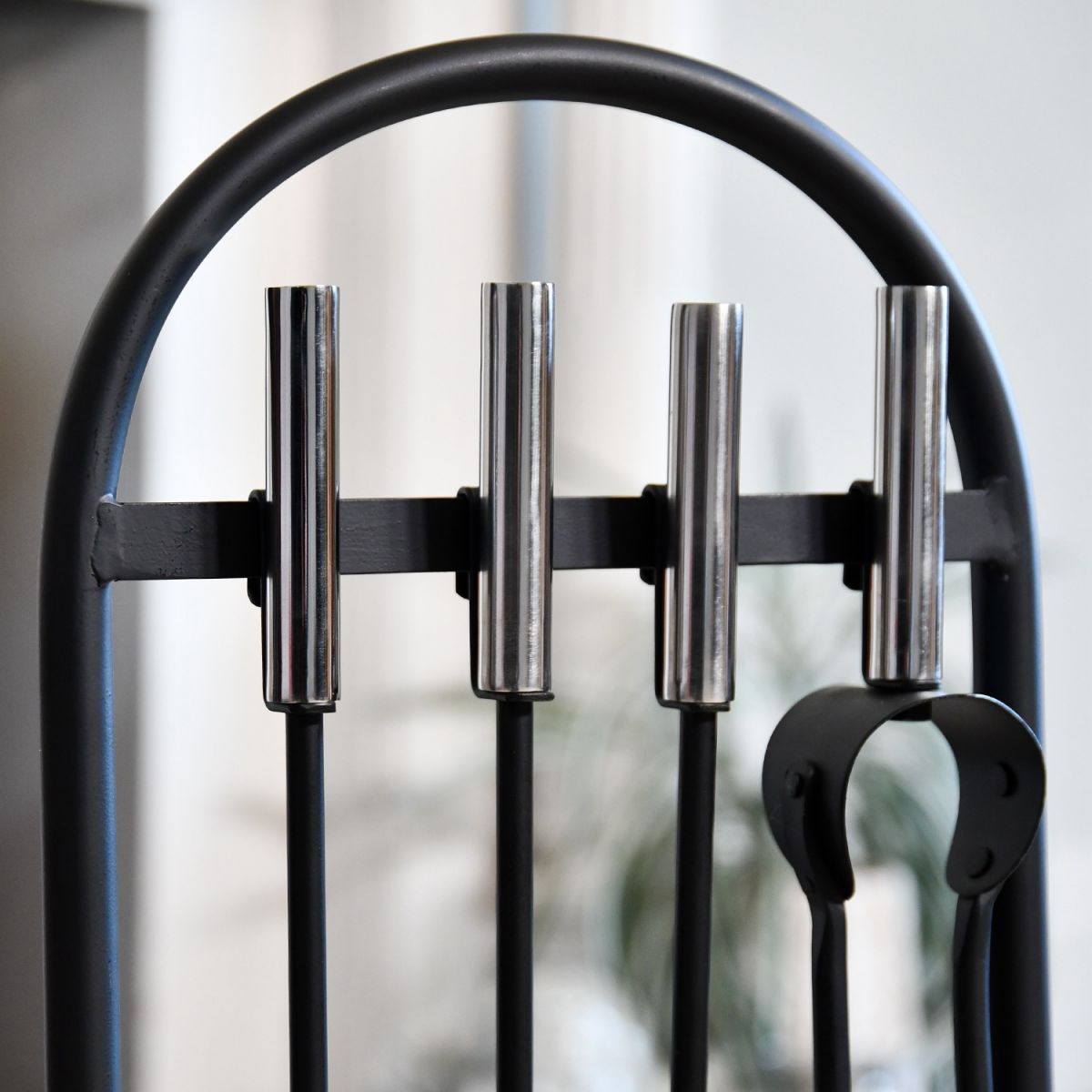 Close up of curved top of modern fireside companion set Close up of curved top of modern fireside companion set