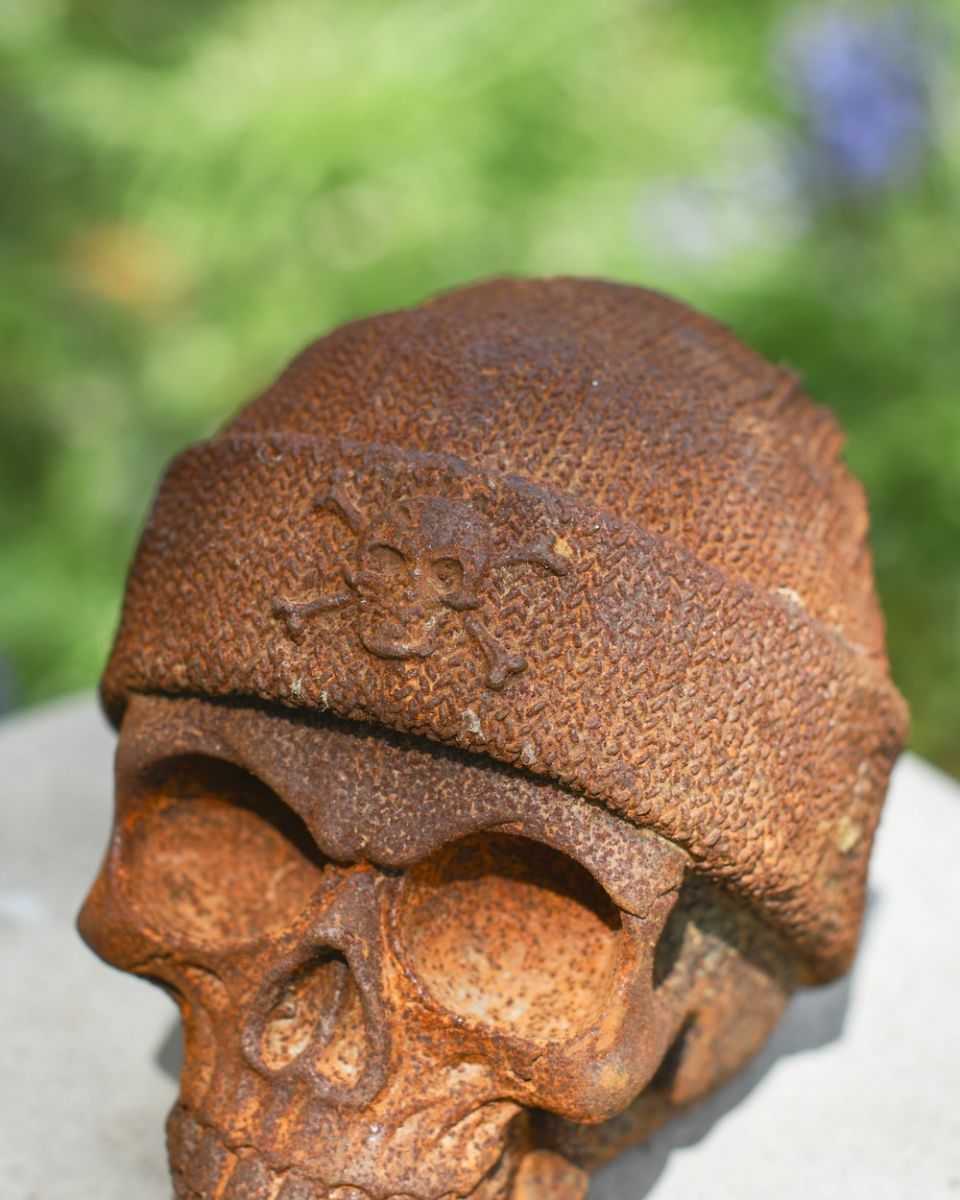Close up of knitted hat detail on rustic finish garden statue