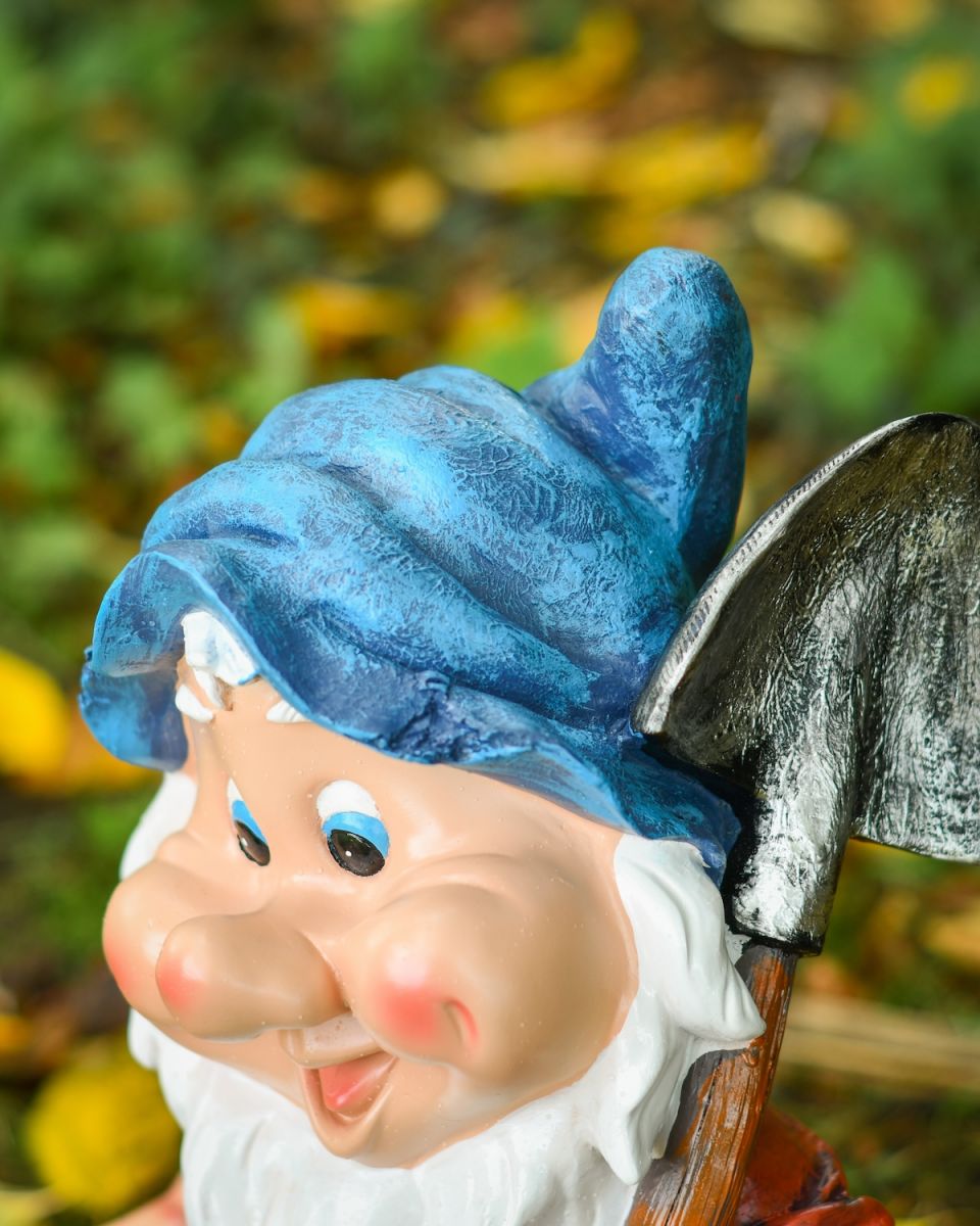 Close up of intricate hat detail on colourful garden gnome sculpture
