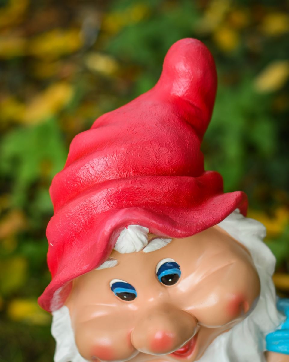Close up of intricate hat detail on colourful outdoor gnome sculpture Close up of intricate hat detail on colourful outdoor gnome sculpture