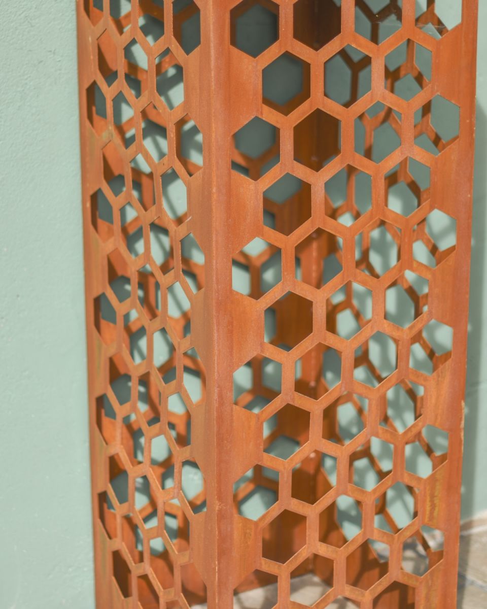Close up of intricate honeycomb detail on decorative plant stand