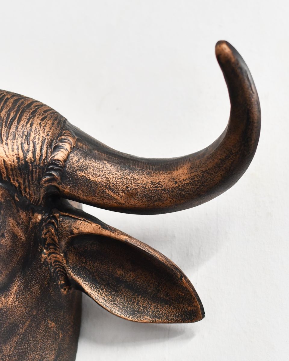 Close up of horn detail on copper buffalo head wall bust