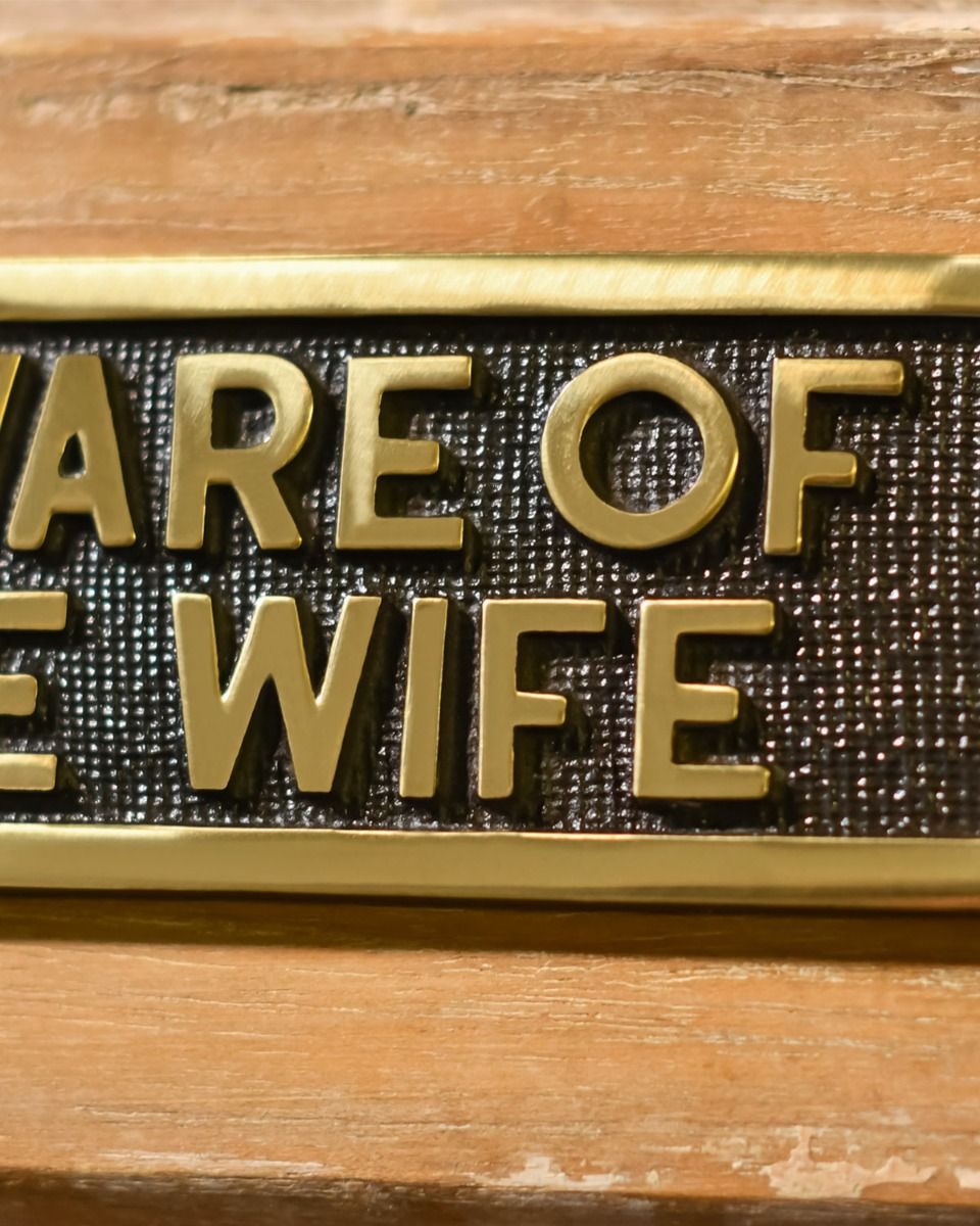 Close up Of Be Aware of the wife - Gate sign