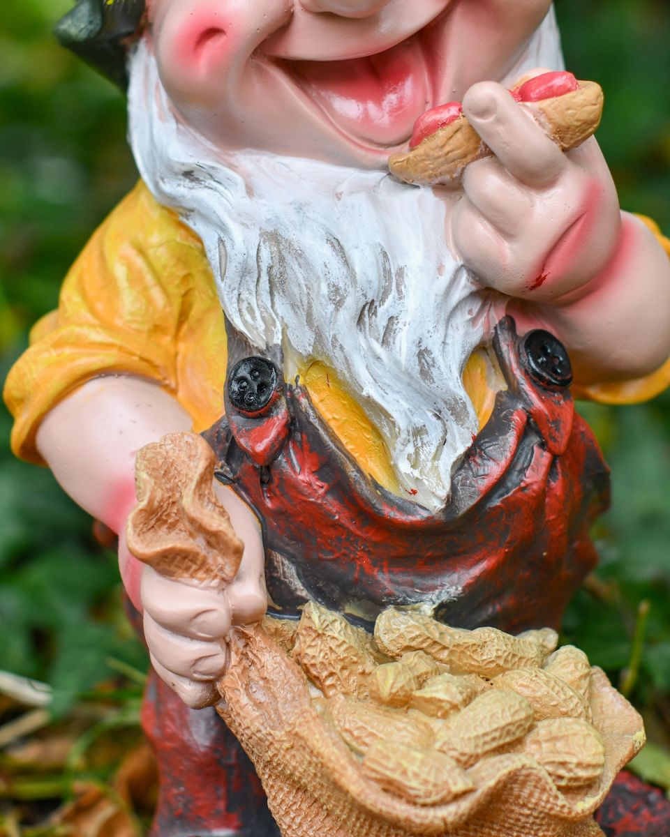 Close up of hair and clothes detail on outdoor garden gnome statue