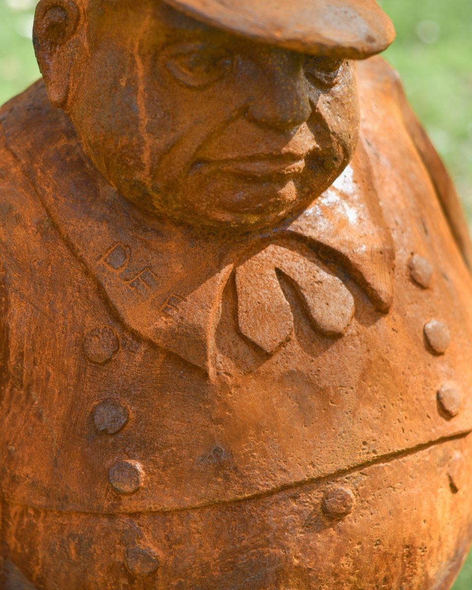 Close up of intricate face detail on tweedledee garden statue Close up of intricate face detail on tweedledee garden statue