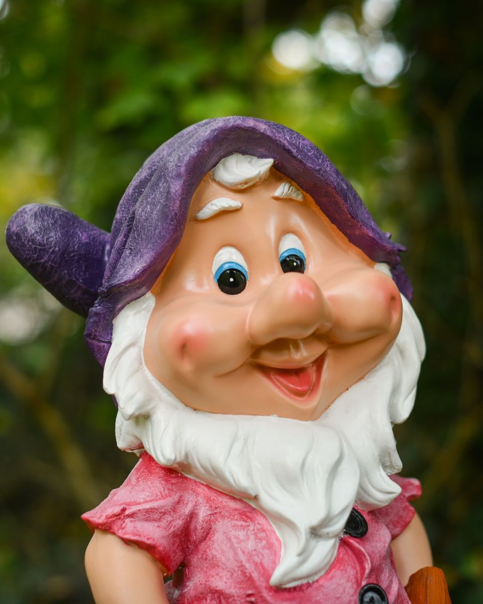 Close up of intricate face detail on colourful garden gnome