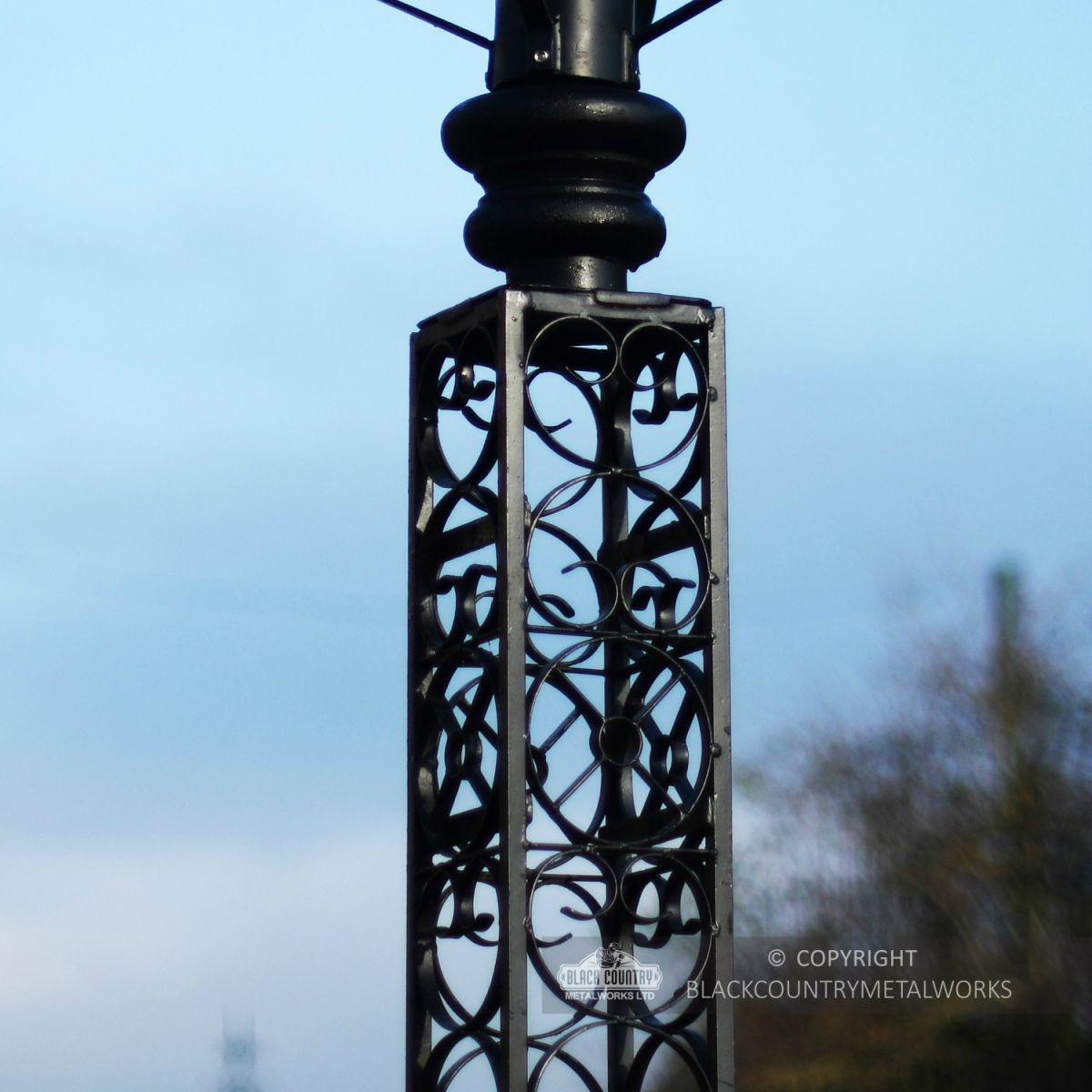 Close Up Of Intricate Scroll Work On Black Lamp Post Column Close Up Of Intricate Scroll Work On Black Lamp Post Column