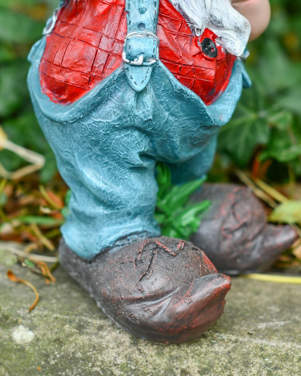 Close up of intricate overall detail on colourful garden gnome statue