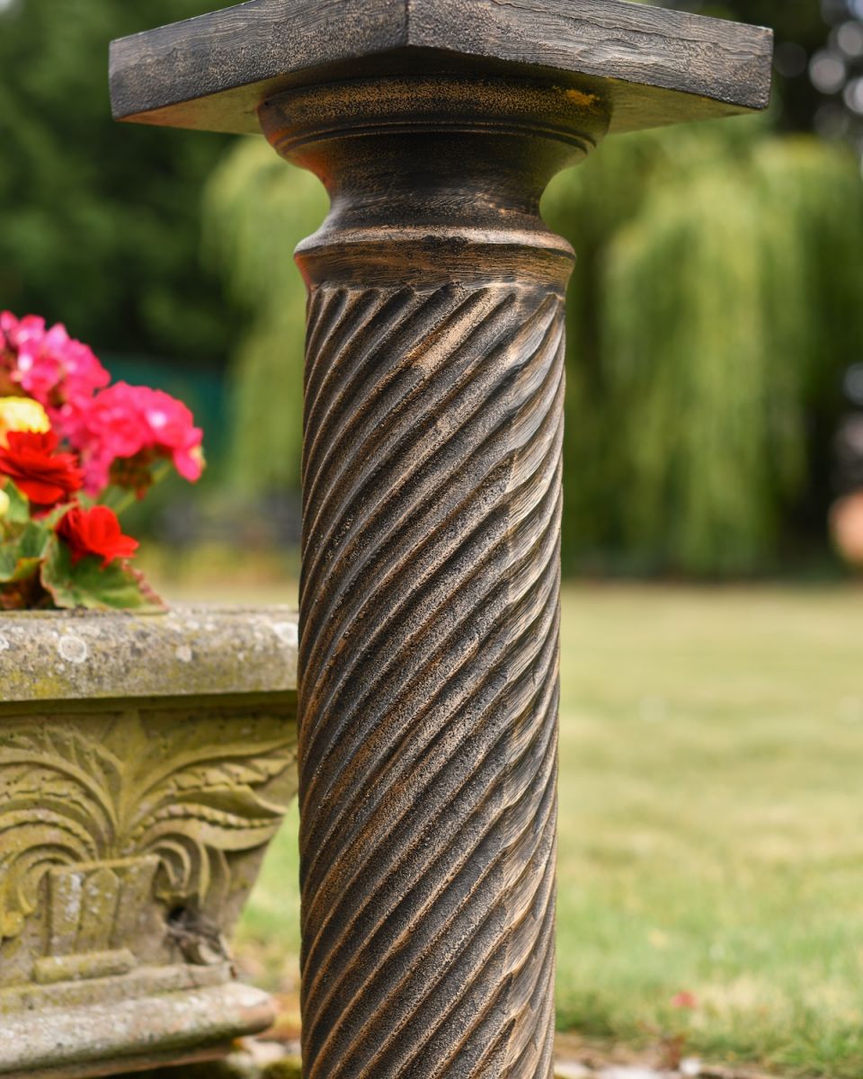 Close up of ornate twist detail on garden plinth