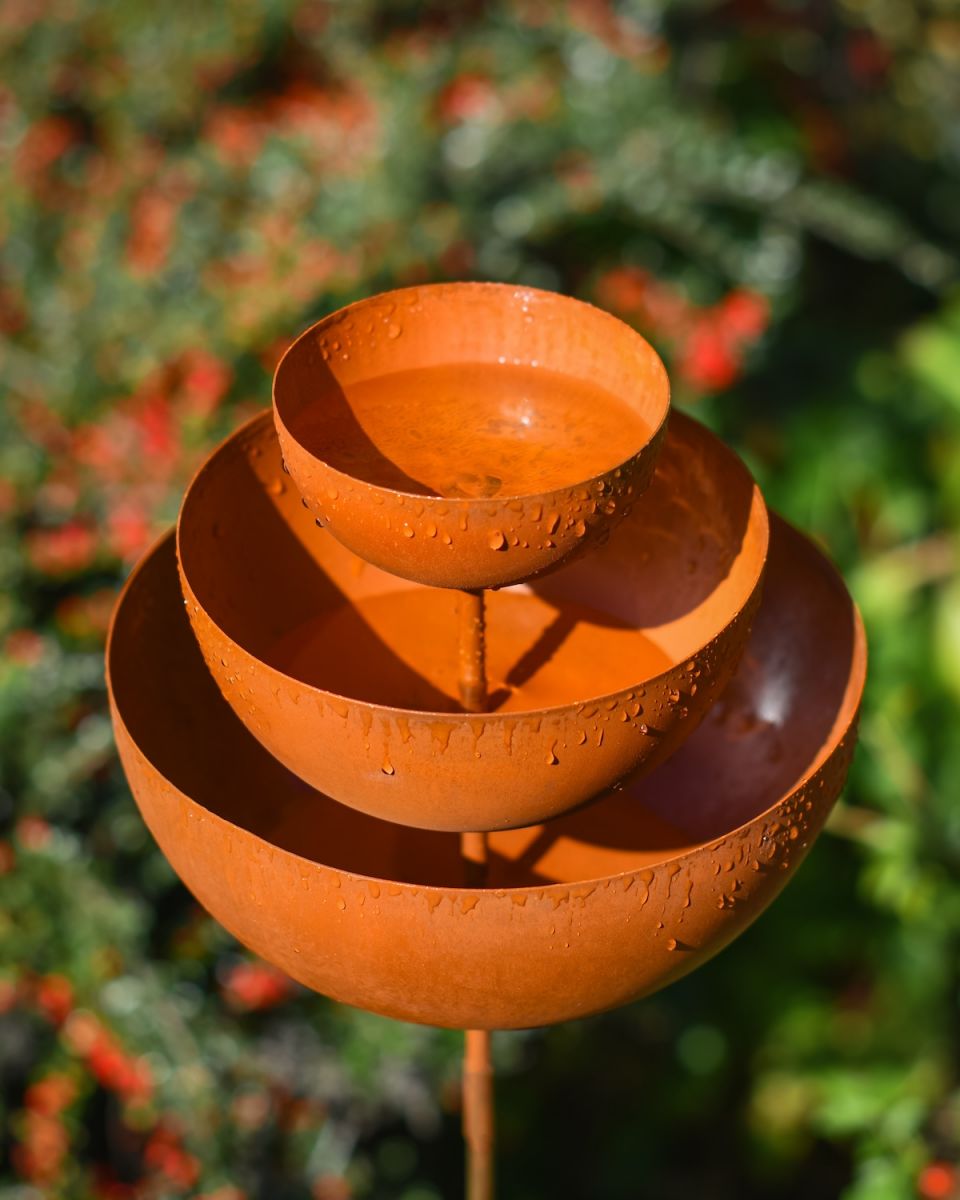 Close up of rustic rain catcher garden ornament