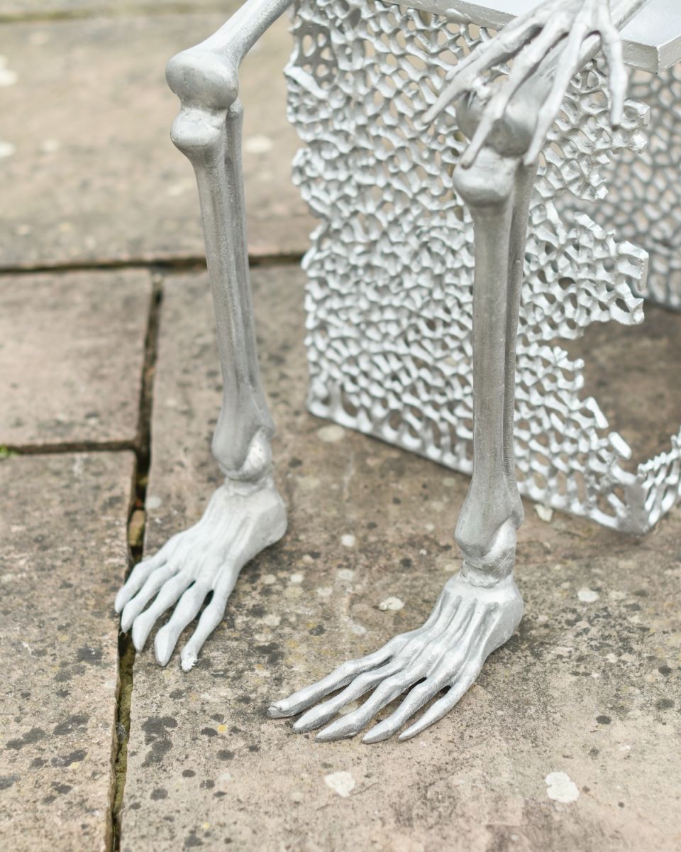 Close up of intricate leg and base detail on skeleton garden sculpture