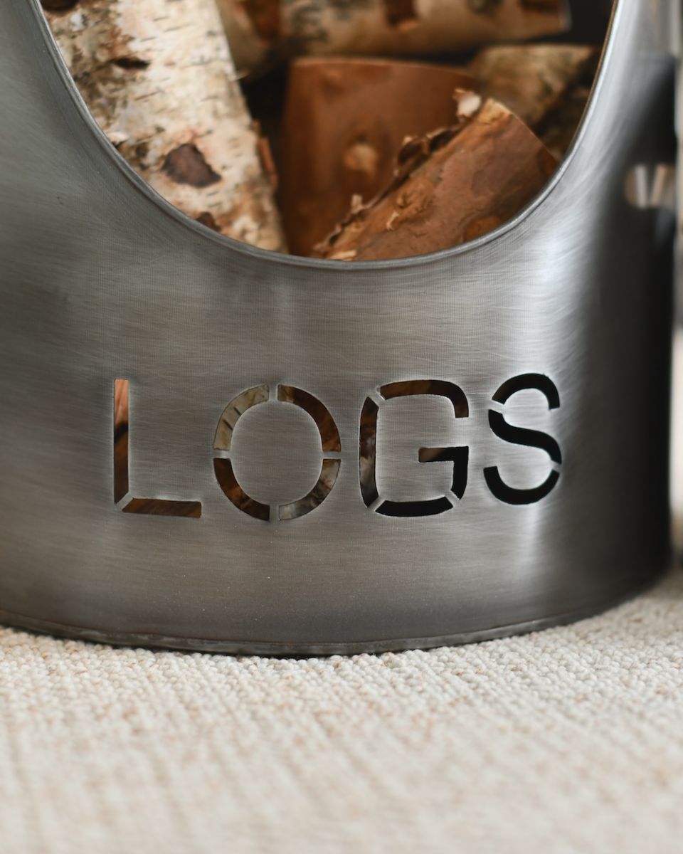 close up view of cut out writing of log fire bucket close up view of cut out writing of log fire bucket