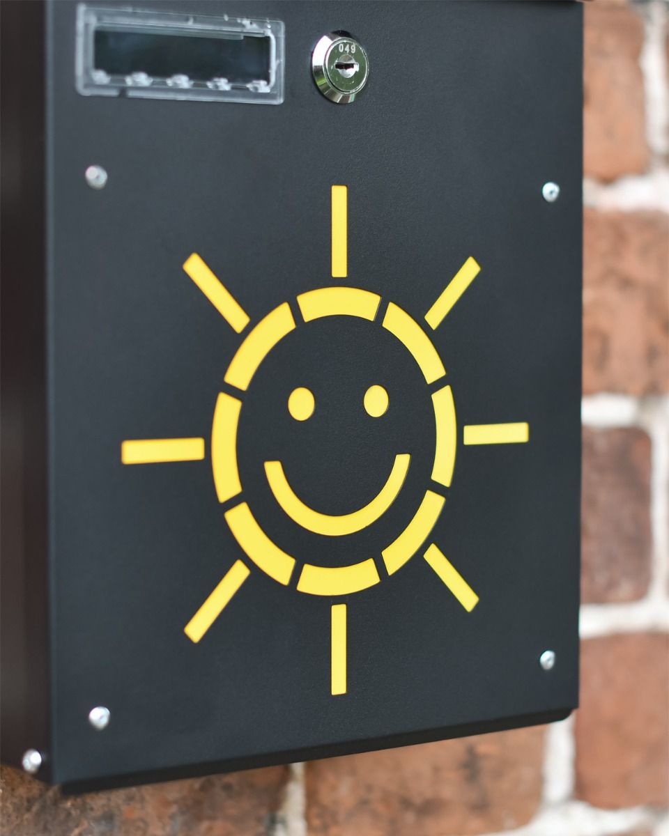 Close Up Of Sun Design On Post Box 