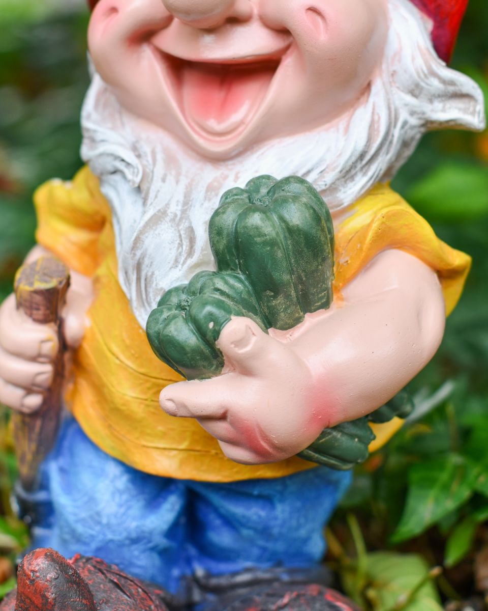 Close up of gardening vegetable detail on colourful garden gnome sculpture