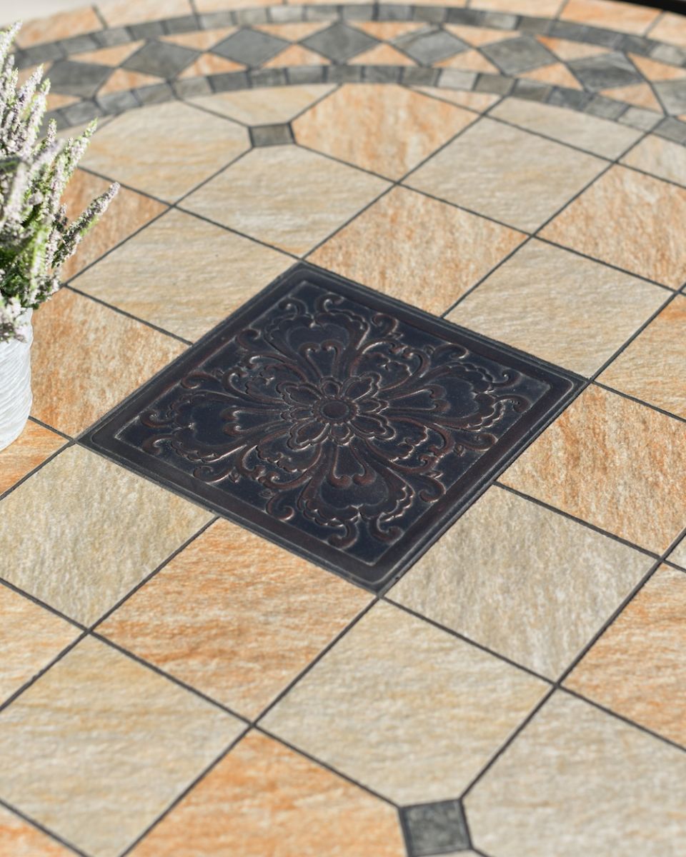 close up of mosaic table top detail on garden dining set