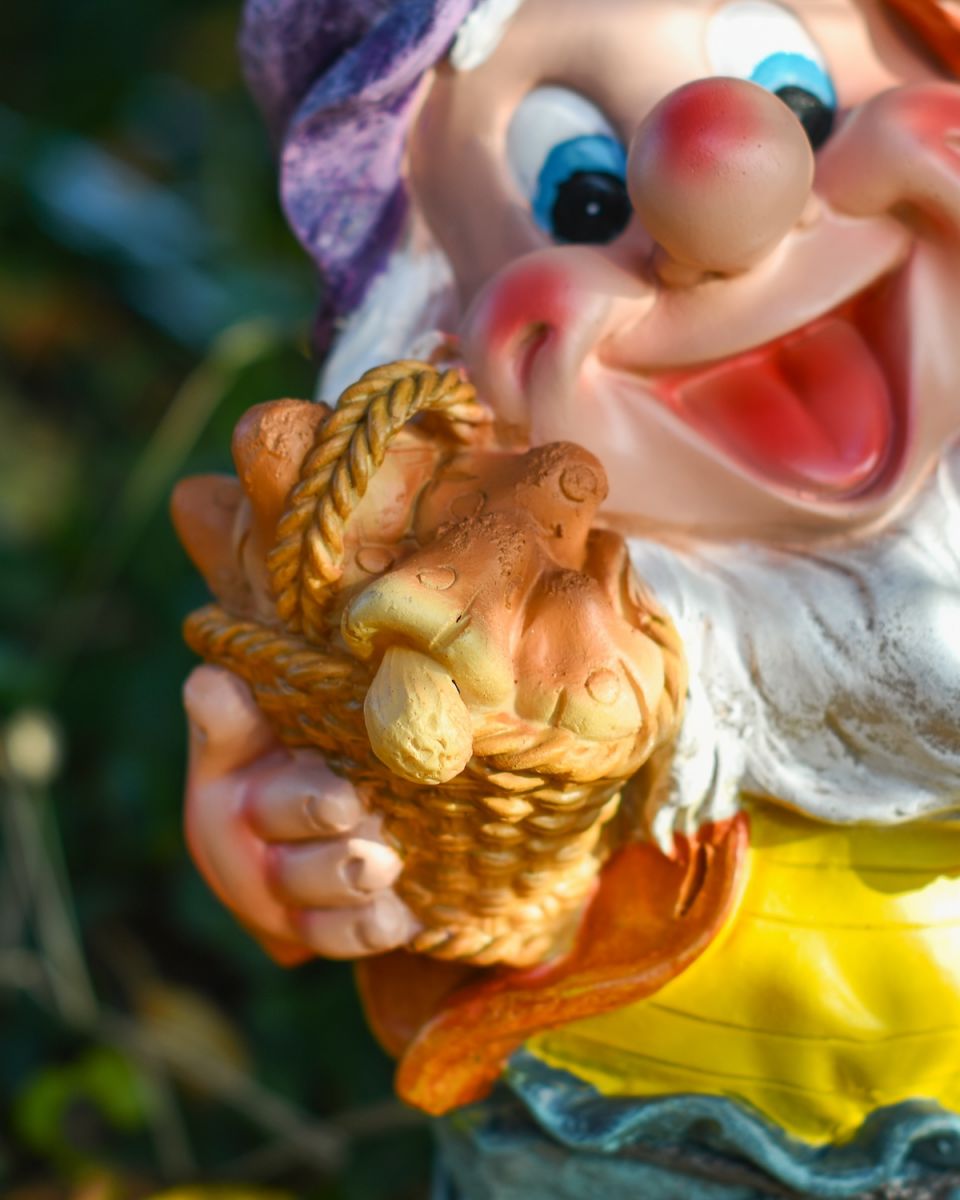 Close up of mushroom basket detail on colourful garden gnome ornament