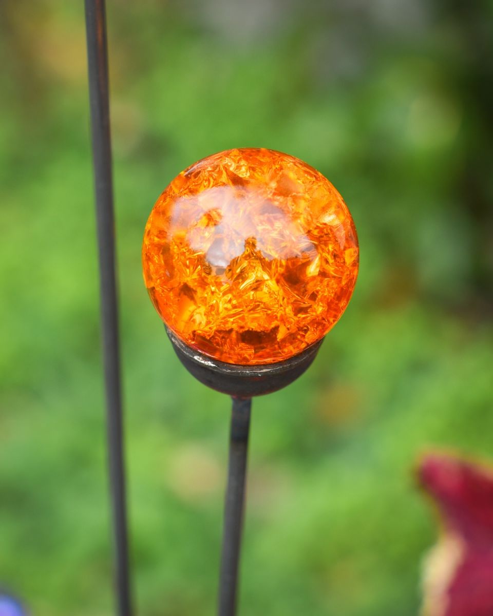 Close up of vibrant orange marble detail on suncatcher garden ornament