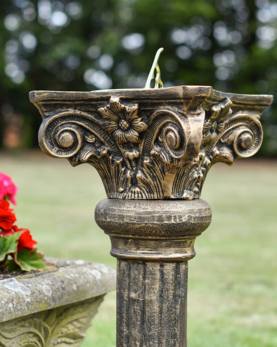 Close up of ornate detailing on garden sundial column