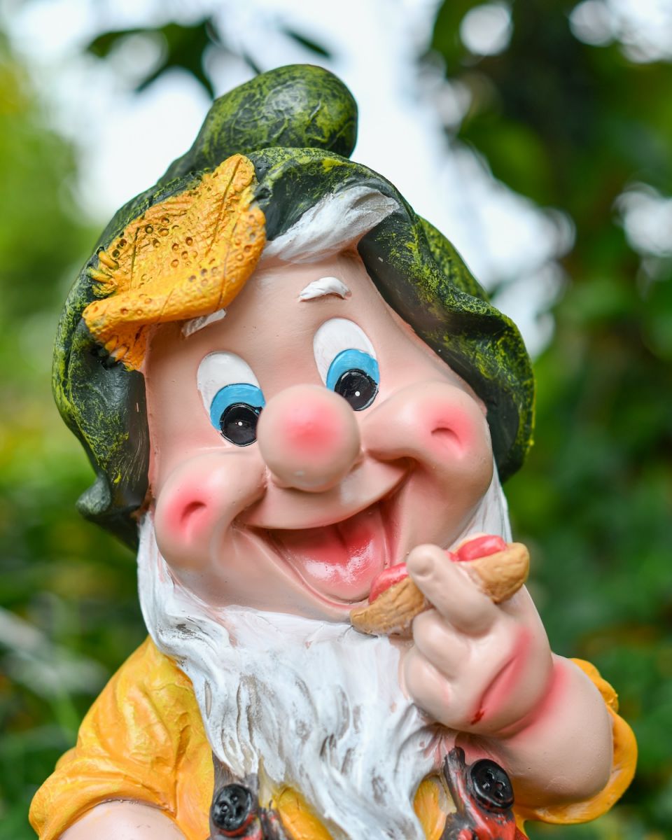 Close up of colourful garden gnome sculpture