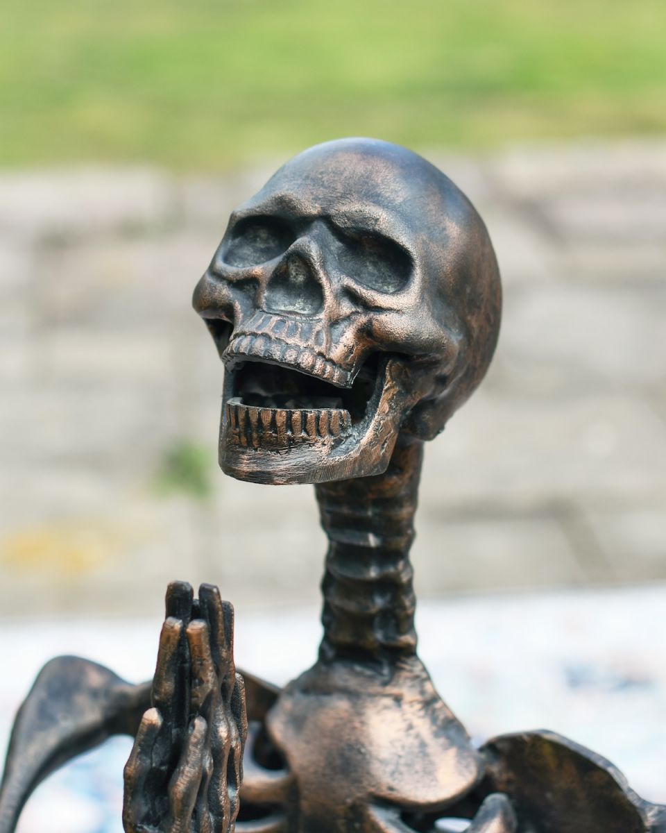 Close up of intricate face detail on skeleton garden sculpture