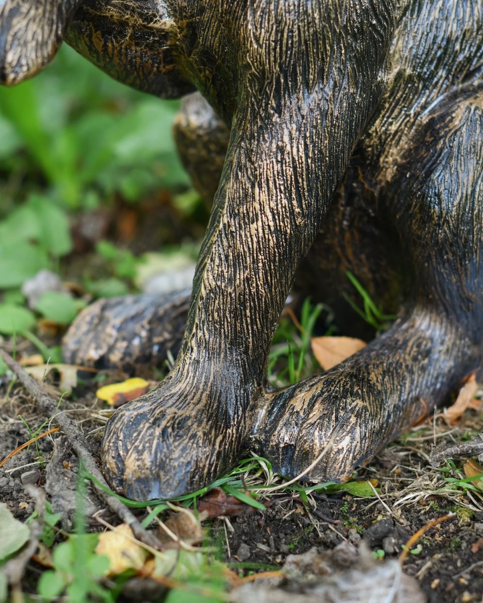 Close up of intricate paw detail on brushed gold hare outdoor statue