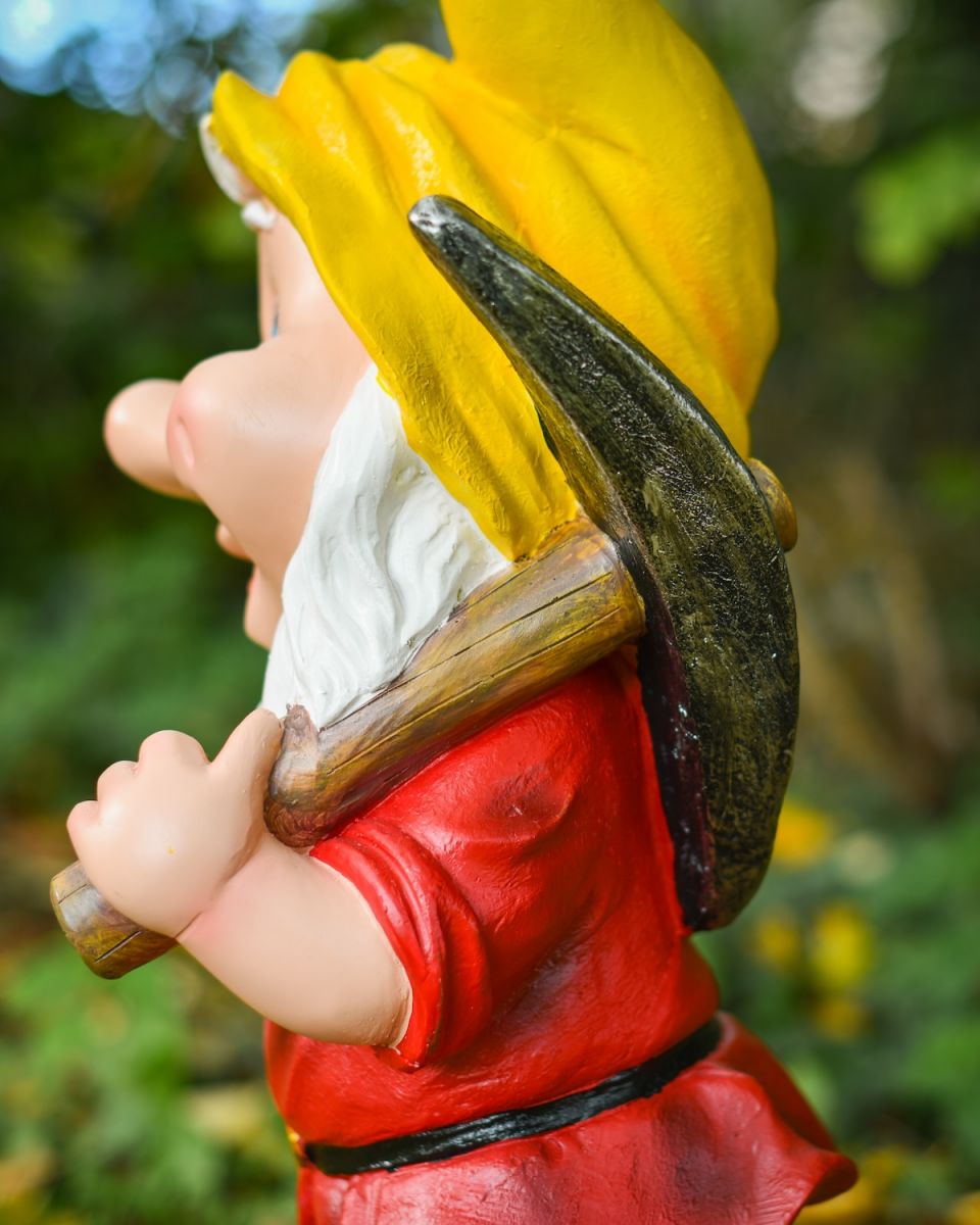 Close up of pickaxe detail on colourful outdoor gnome sculpture