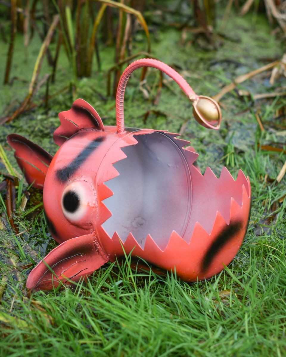 Close up of red anglerfish on recycled metal garden sculpture