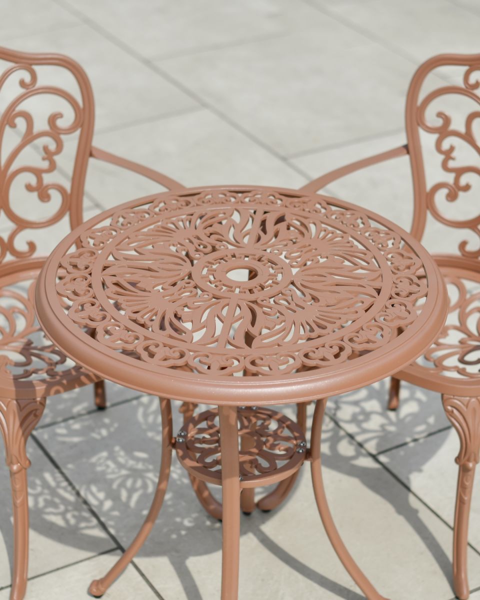 Close up of intricte table top detail with parasol hole on garden furniture set
