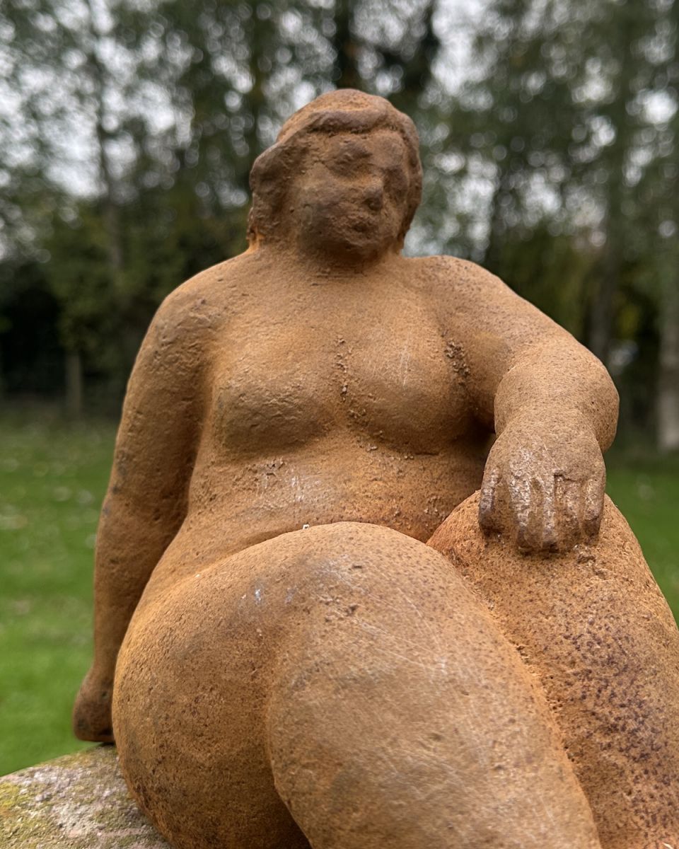 Close up of lounging woman silhouette garden sculpture