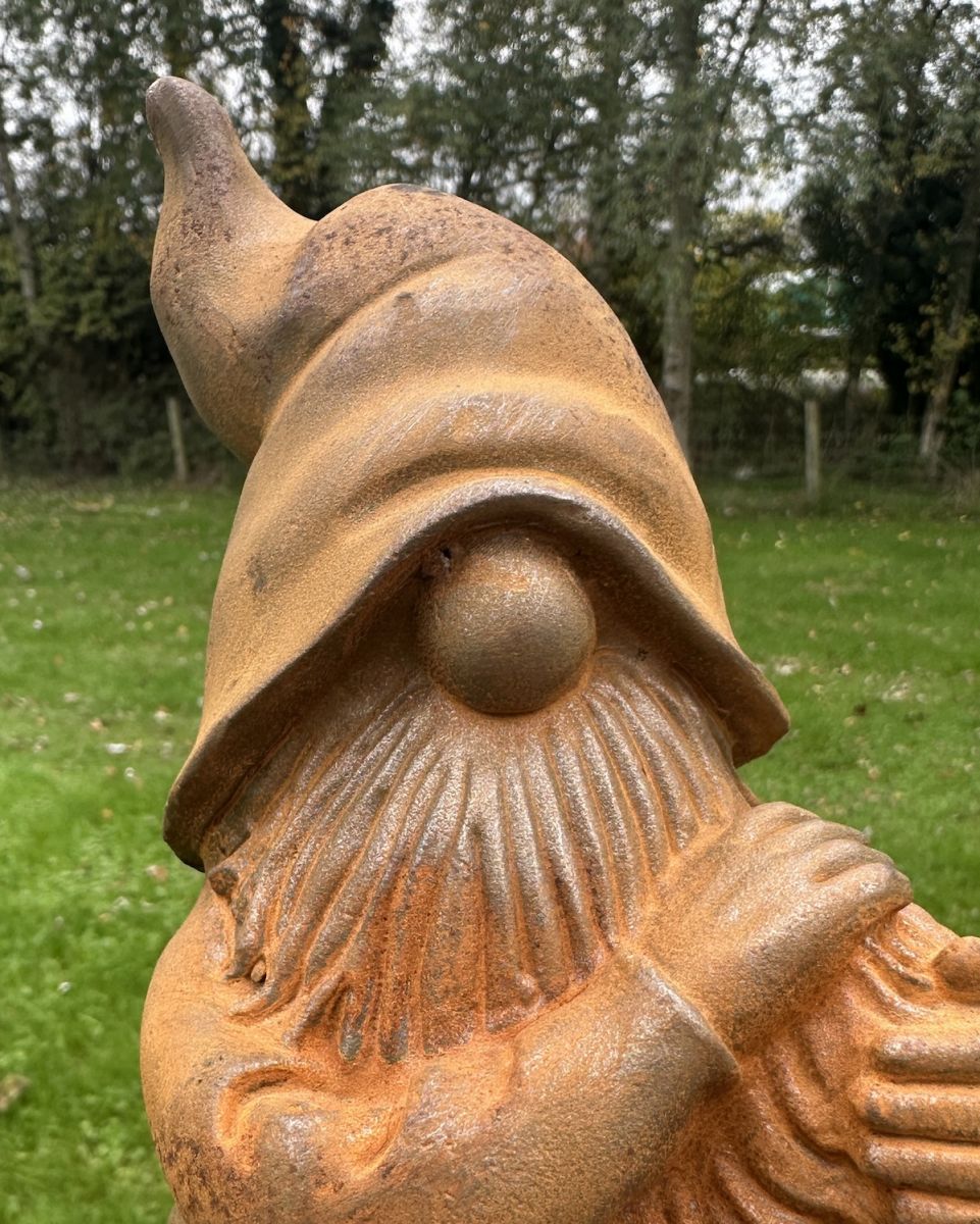 Close up of intricate detail on rustic finish garden gnome ornament Close up of intricate detail on rustic finish garden gnome ornament