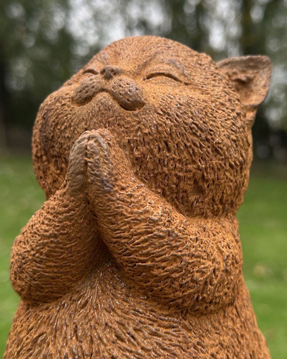 Close up of intricate face detail on cat garden sculpture