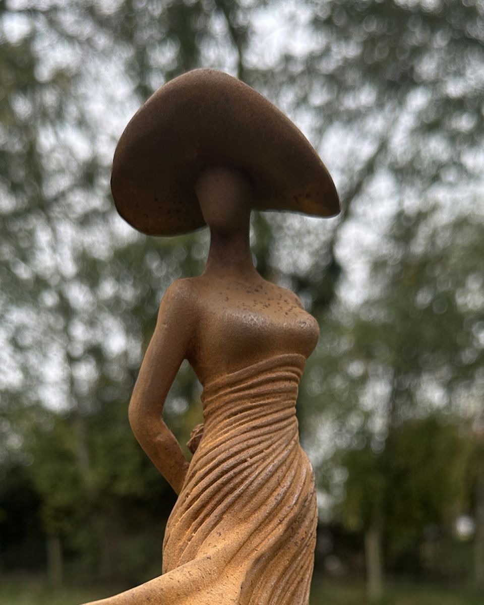 Close up of silhouette detailing on rustic finish dancing lady garden sculpture