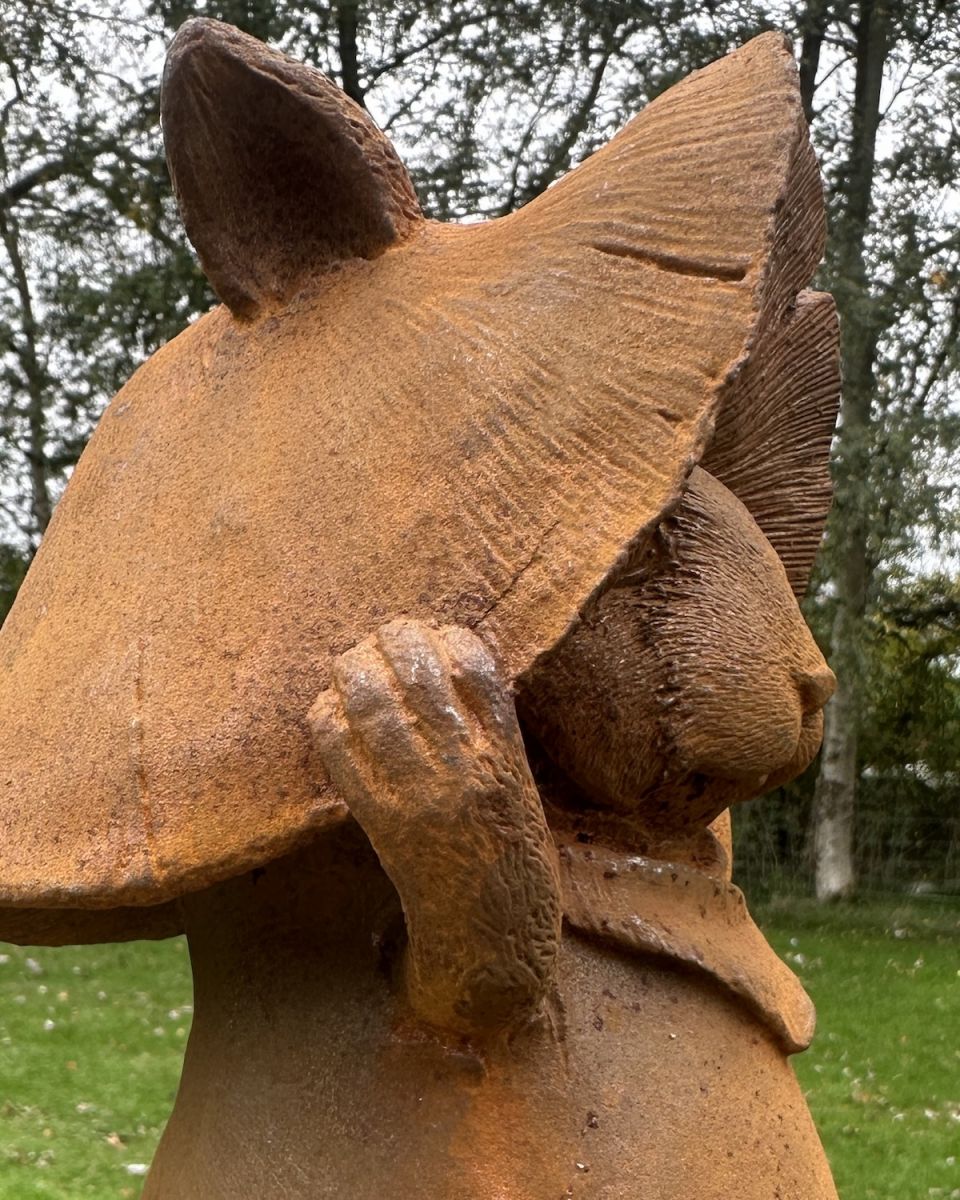 Close up of mushroom hat detail on rustic finish garden sculpture Close up of mushroom hat detail on rustic finish garden sculpture
