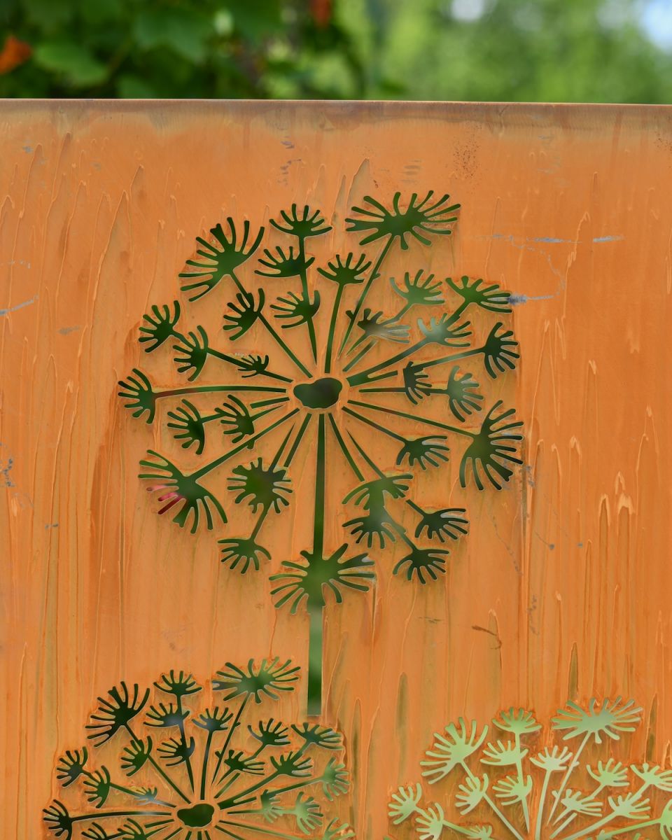 Close up of dandelion cut out detail on rustic garden art