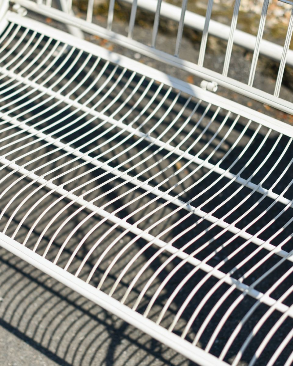Close up of intricate seat detail on garden swing bench