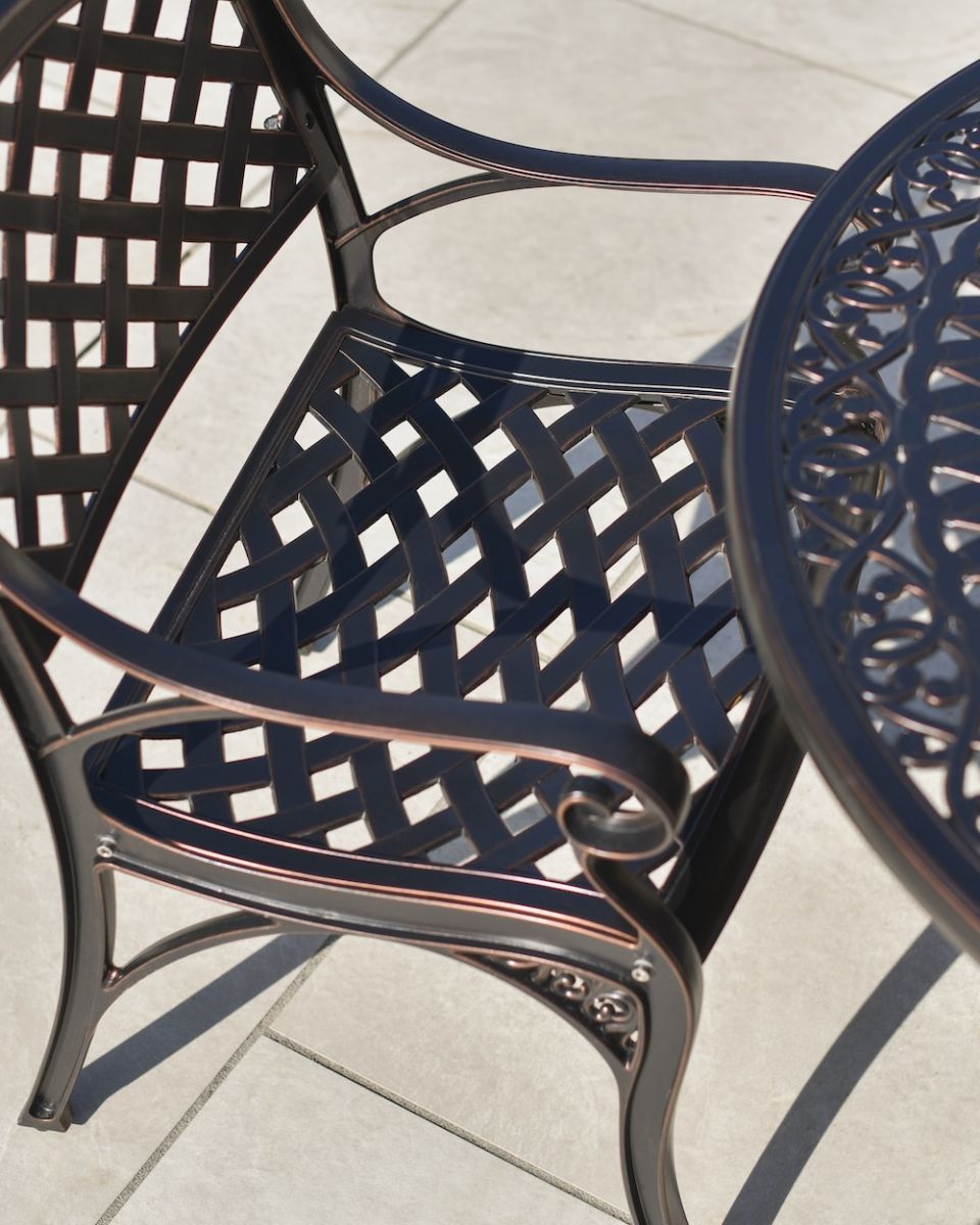 detailed close up of aluminium chair lattice detail on antique copper chair set detailed close up of aluminium chair lattice detail on antique copper chair set