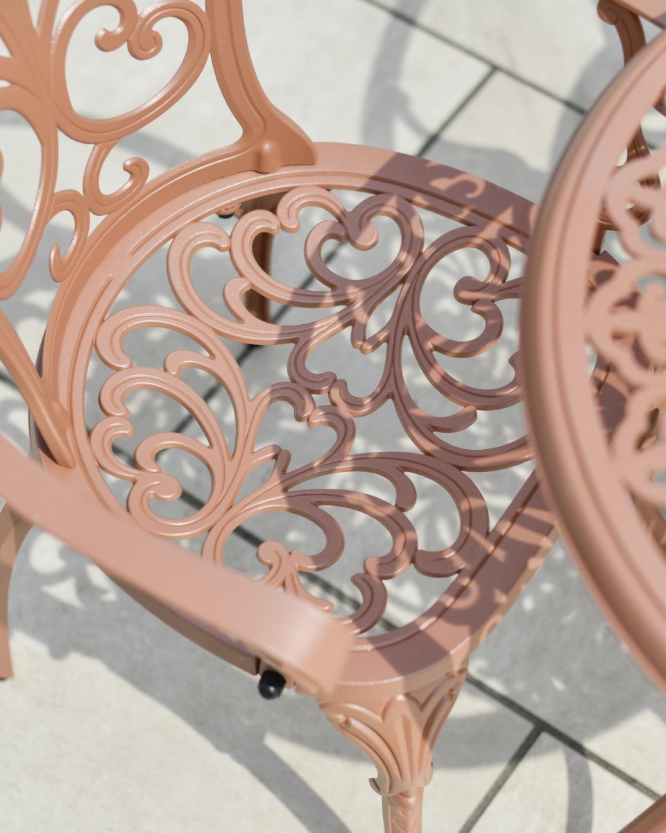 Close up of ornate seat detailing on two seater outdoor table and chairs set