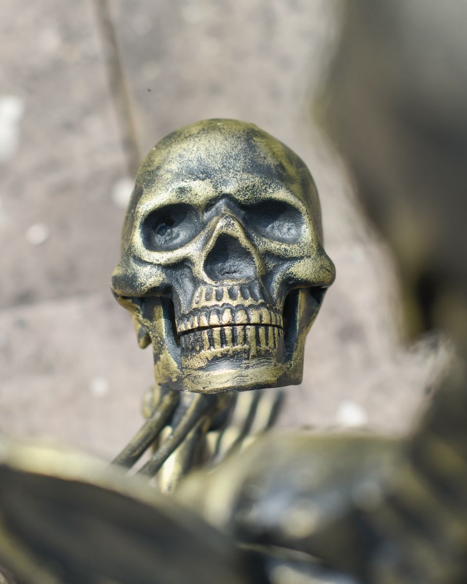 Close up of intricate skull detail on skeleton garden statue