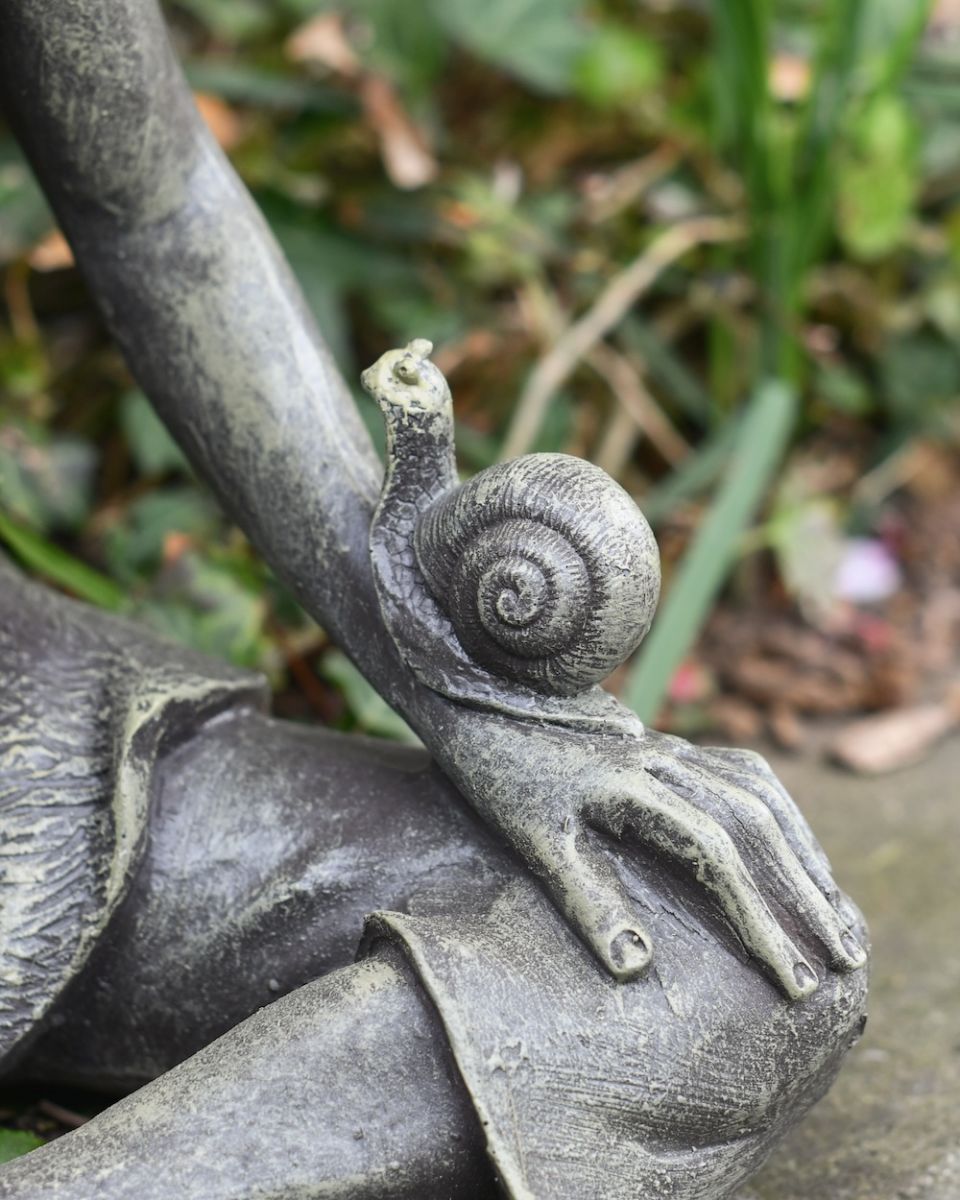 close up of snail and hand detail on pixie garden statue