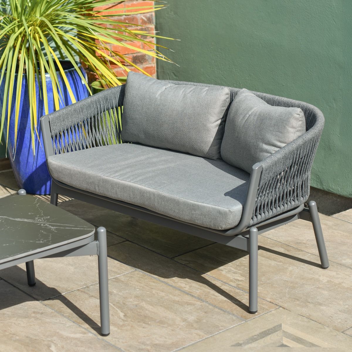 Close up of two seater sofa on five seater garden furniture lounge set