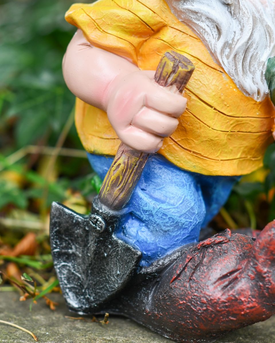 Close up of spade on gardening gnome sculpture
