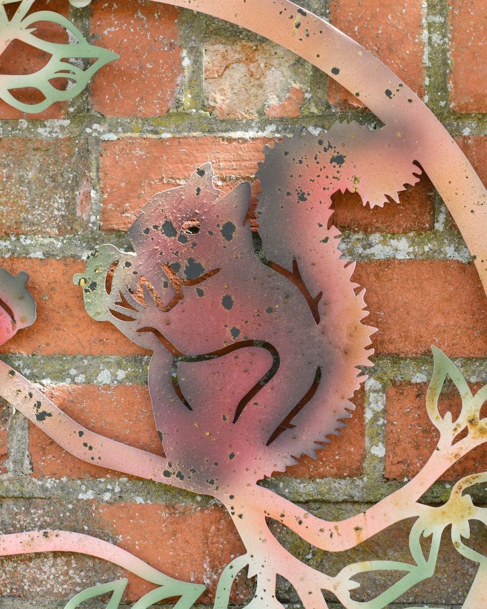 Close up of squirrel detail on rustic finish outdoor wall art
