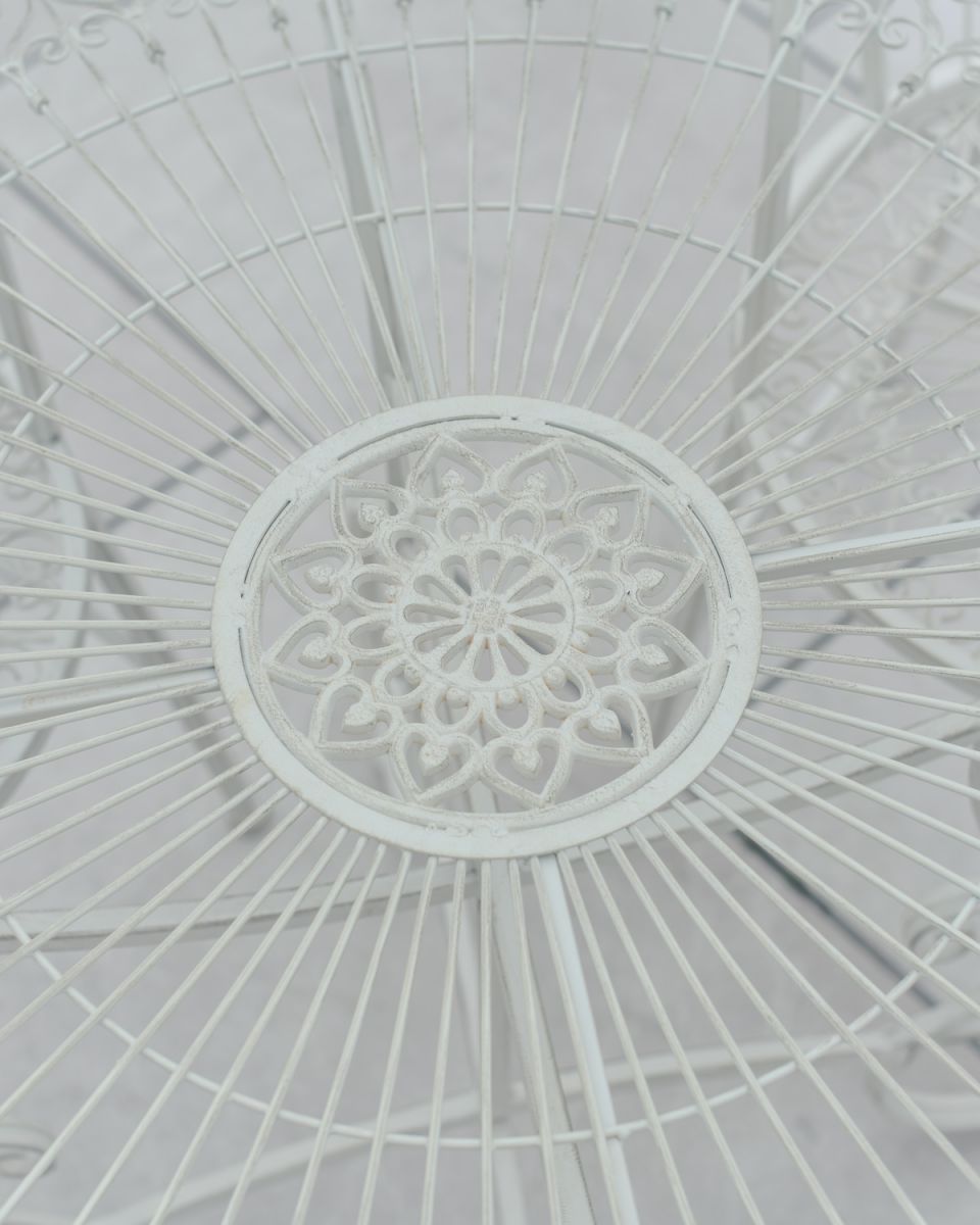 Close up of ornate table top detail on four seater patio dining set Close up of ornate table top detail on four seater patio dining set