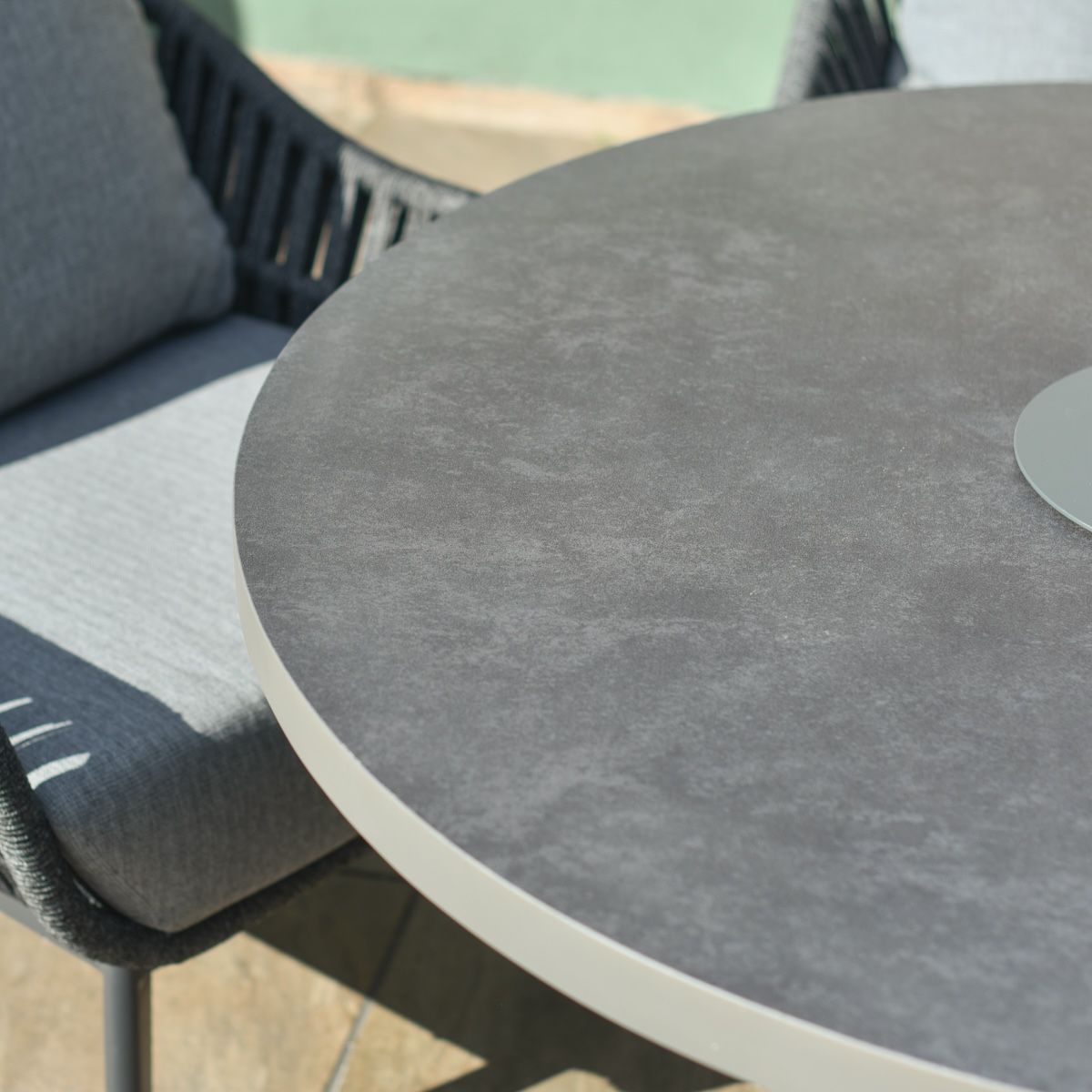 Close up of engineered stone tabletop on four seater modern garden furniture set