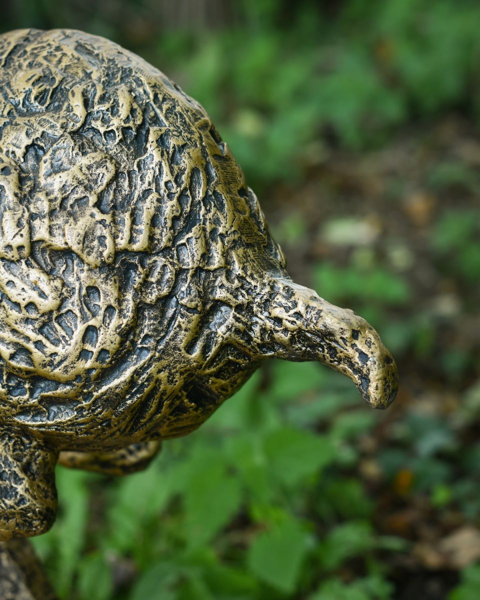 Close up of brushed gold sprinting hare garden statue